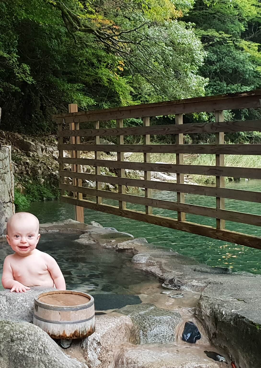 Baby smiling in a hot spring pool.