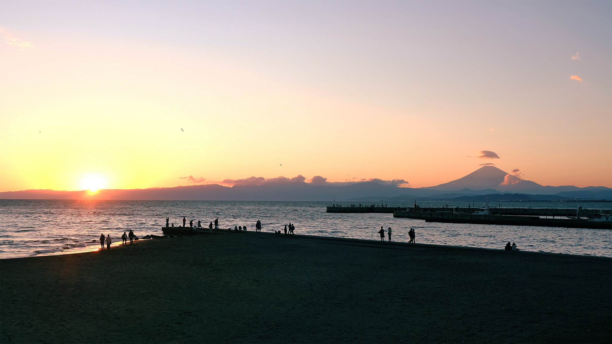 Sunset view of Mt. Fuji with Enoshima beach in the foreground.