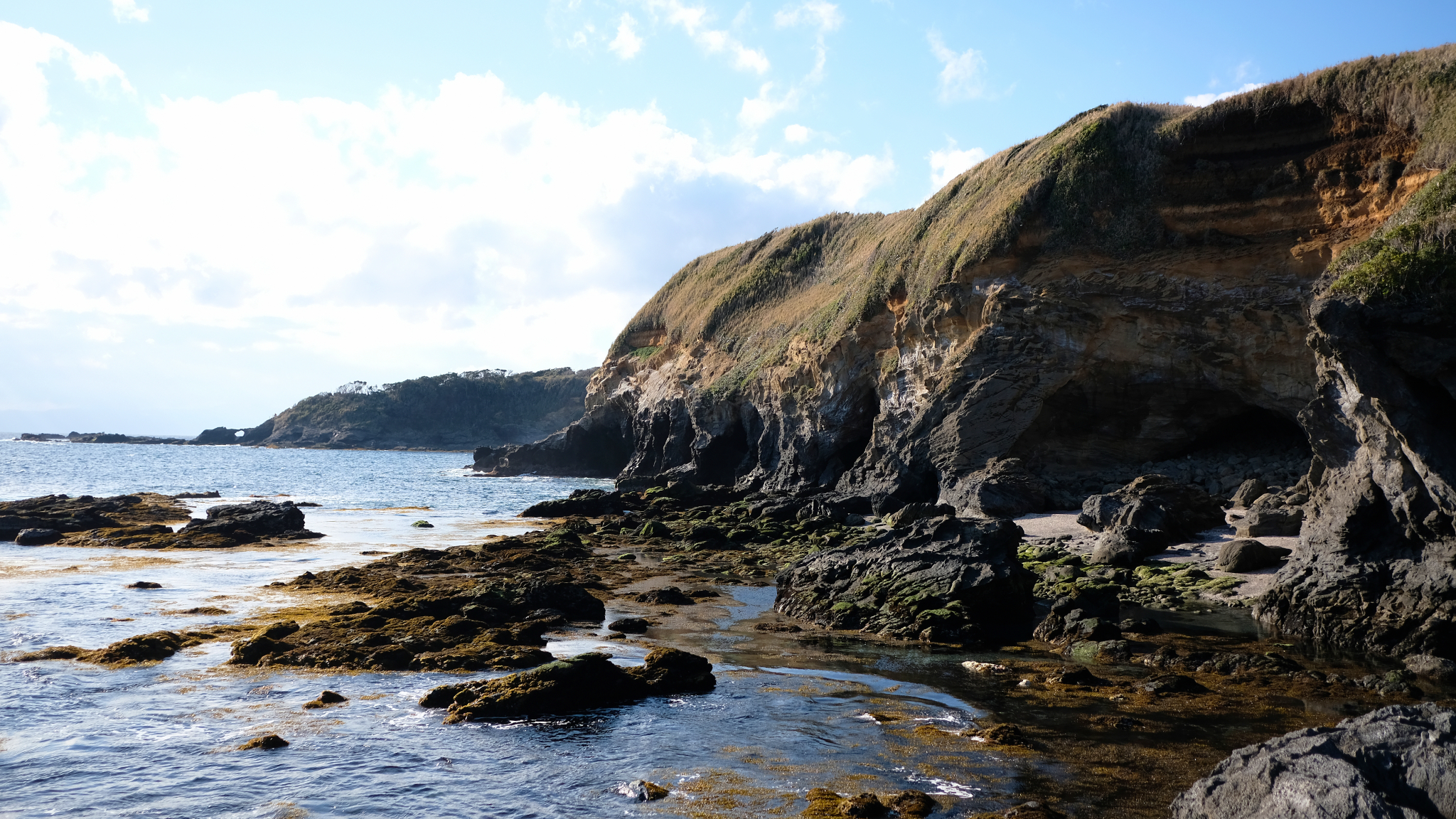 Rounded cliff edges near the ocean water.